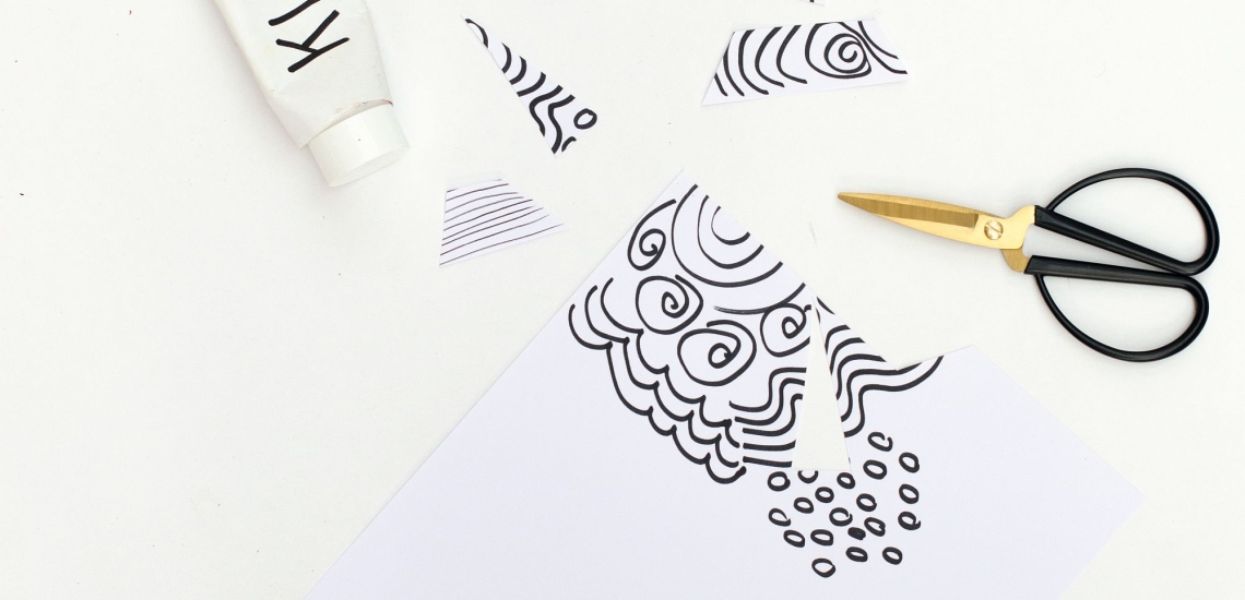 Kleber, Schere und schwarze Muster auf weißem Papier 