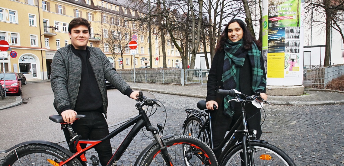 Zwei Jugendliche mit Fahrrädern in Stadt