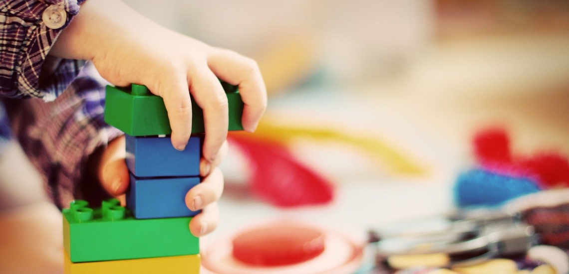 Kinderhände mit Legosteinen 