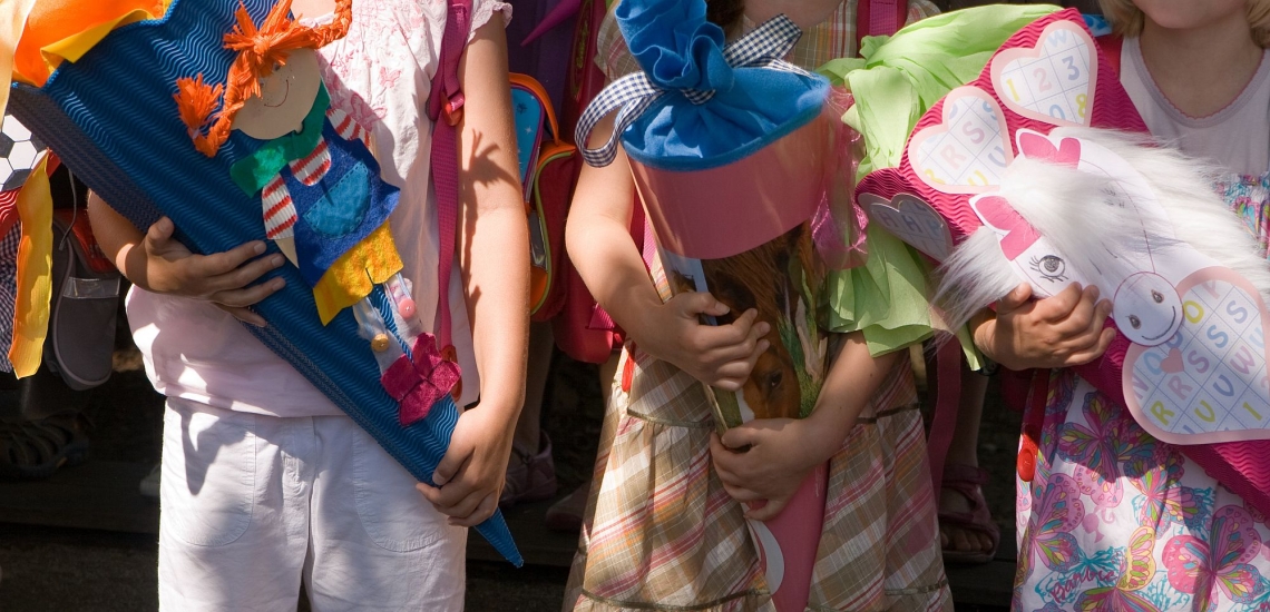 Bunte und schön verzierte Schultüten werden von Kindern gehalten