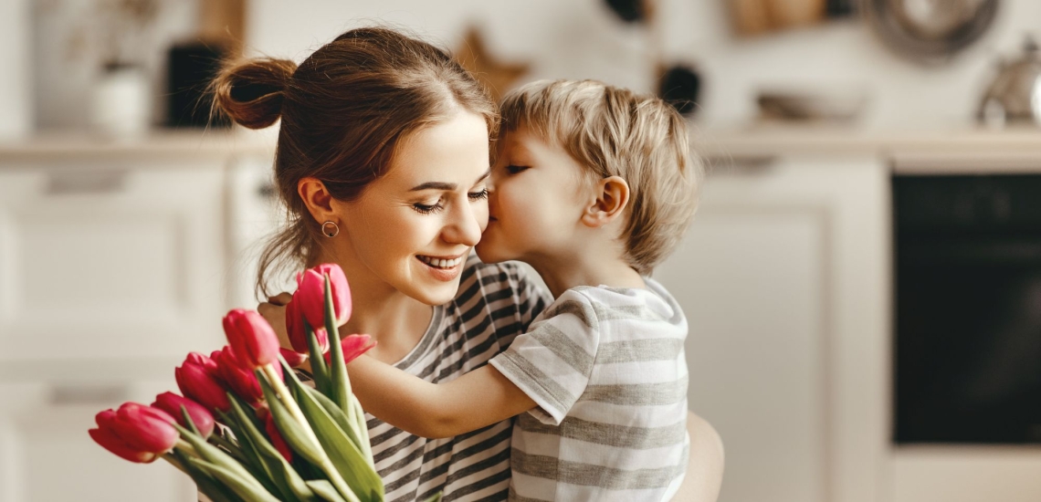 Mutter und Kind liebevoll mit Blumenstrauß 