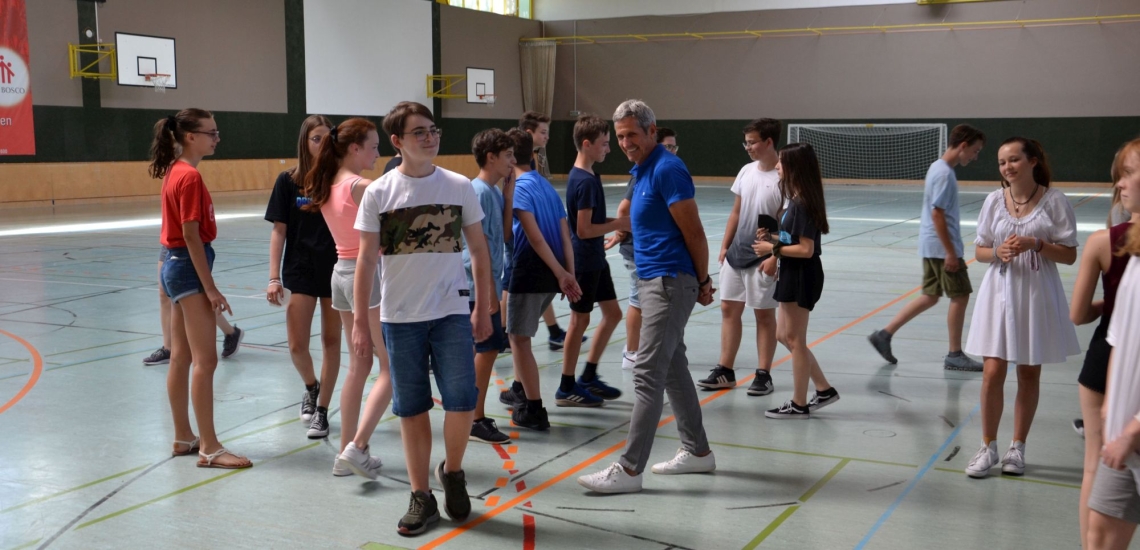 Lehrer mit Klasse in Turnhalle 