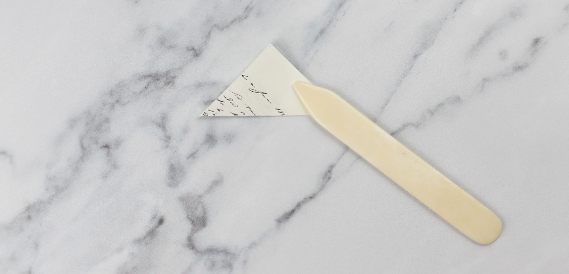 Gefalztes Papierquadrat mit Falzbein