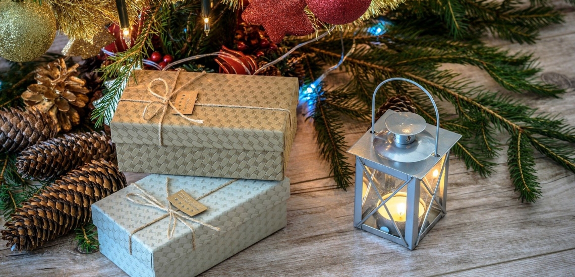 Weihnachtsgeschenke liegen unter geschmücktem Christbaum