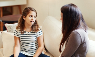 Eine Mutter im Gespräch mit ihrer etwa 10-Jährigen Tochter.