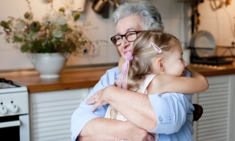 Oma und Enkelin umarmen sich liebevoll 