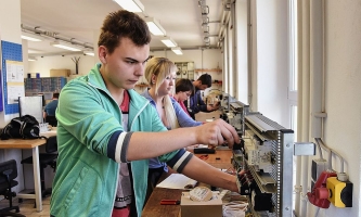 Junger Mann arbeitet an elektrischen Geräten im Don Bosco Jugend-Werk Sachsen 